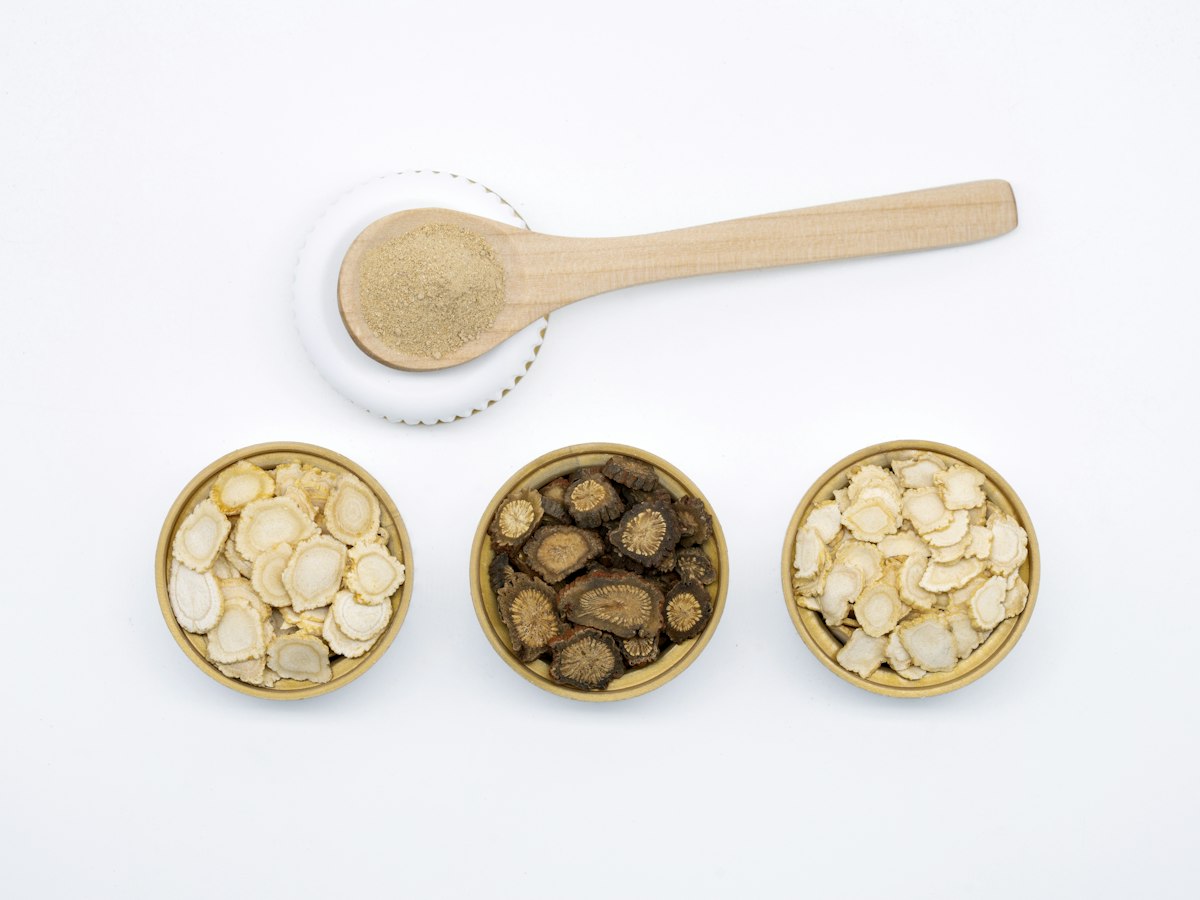 Traditional Chinese herbs in small wooden bowls